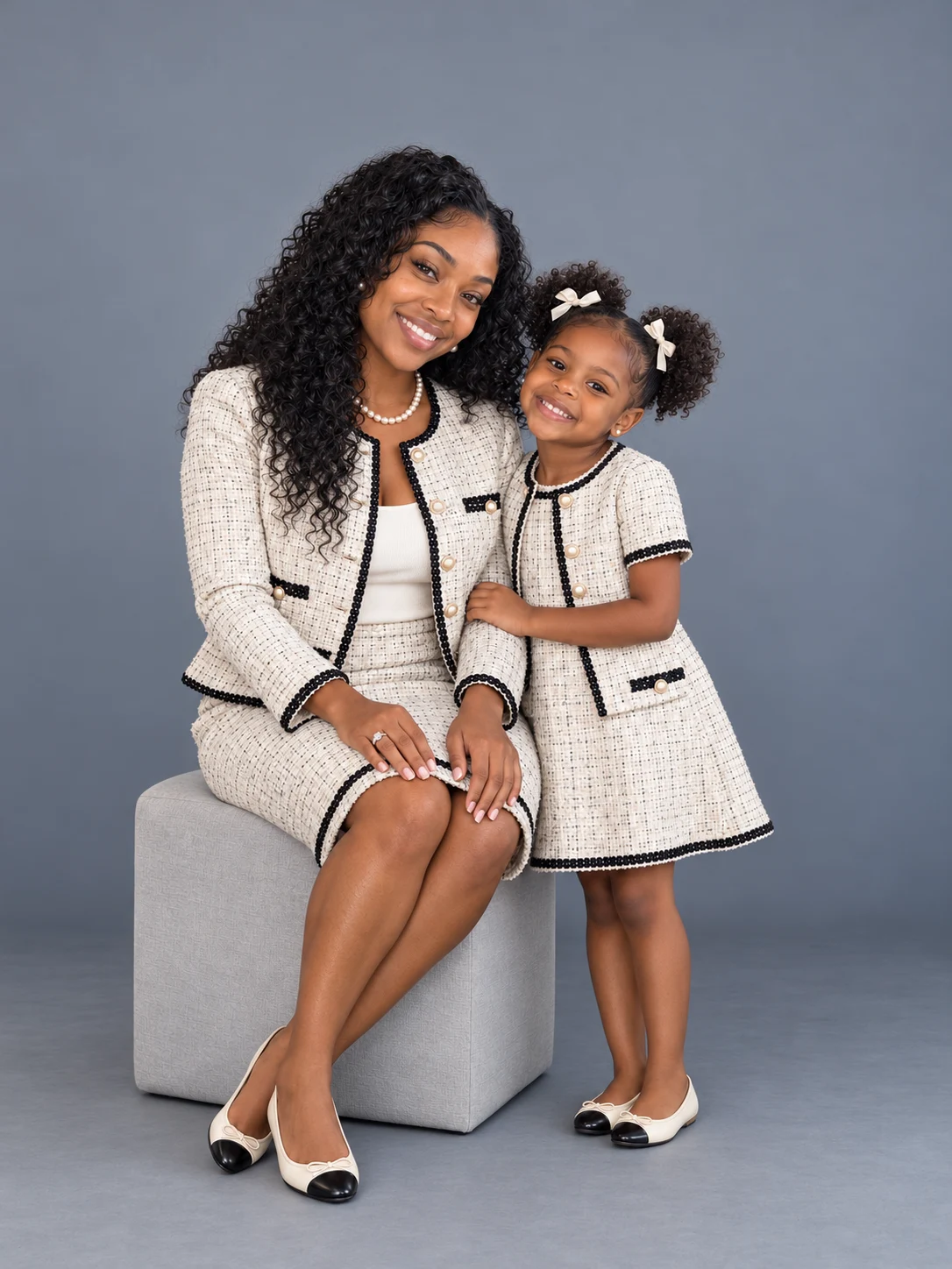 Mother and young daughter in coordinated cream outfits